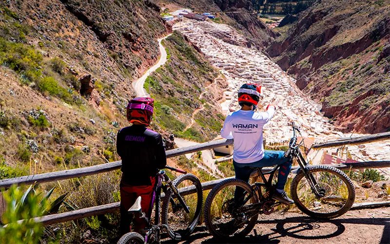 Group of bikers stopped at viewpoint overlooking the Salineras de Maras salt flats (Peru Biking Tours)